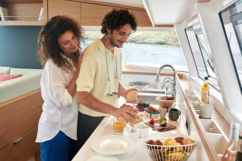  Yacht Photos Pics Couple enjoying breakfast in the kitchen of a 2026 Bali CATSMART yacht.