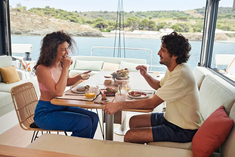  Yacht Photos Pics Couple enjoying breakfast on a Bali CATSMART 2026 yacht, with scenic ocean view.