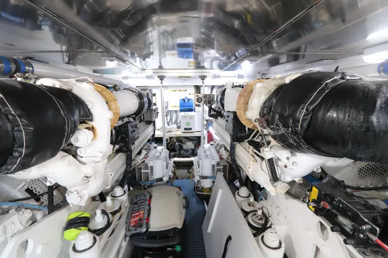 Bolita Yacht Photos Pics Engine room of a 2002 Buddy Davis 74 yacht, showcasing dual engines and mechanical components.