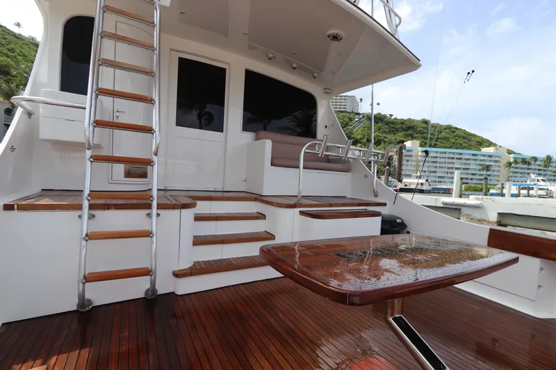 Bolita Yacht Photos Pics Luxury yacht deck with wooden flooring, ladder, and seating area; Buddy Davis 74, 2002 model.