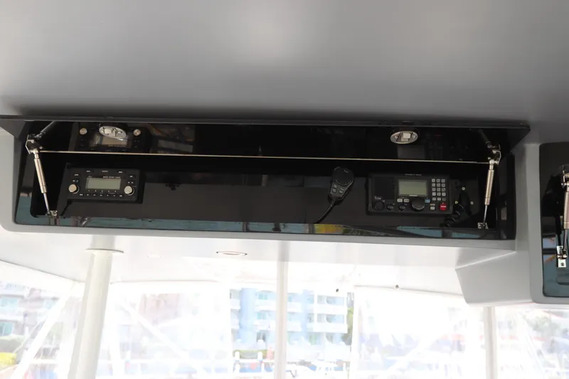 Bolita Yacht Photos Pics Overhead console with communication equipment on a 2002 Buddy Davis 74 yacht.