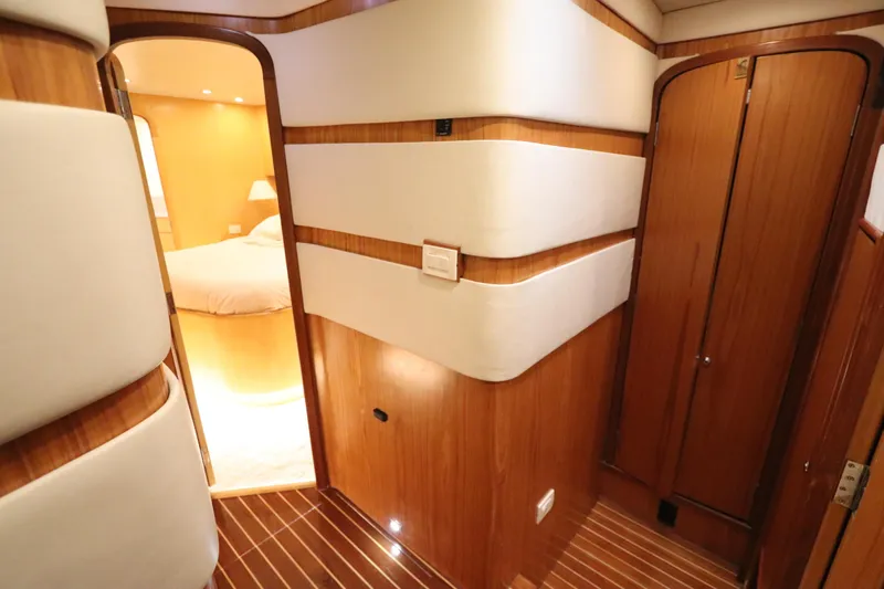 Bolita Yacht Photos Pics Luxurious interior of 2002 Buddy Davis 74 yacht with wood paneling and cozy bedroom.