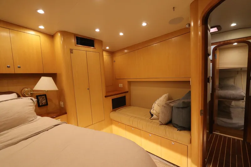 Bolita Yacht Photos Pics Luxurious cabin interior of 2002 Buddy Davis 74 yacht with cozy seating and elegant wood finish.