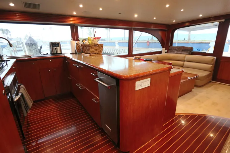 Bolita Yacht Photos Pics Luxurious interior of 2002 Buddy Davis 74 yacht with elegant wood finishes and spacious seating.