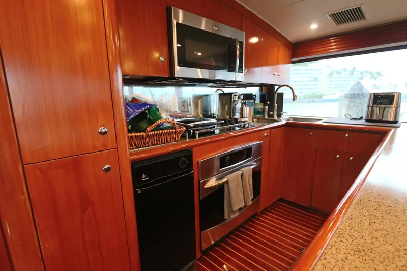 Bolita Yacht Photos Pics Luxurious kitchen interior on a 2002 Buddy Davis 74 yacht, featuring modern appliances and wood cabinetry.