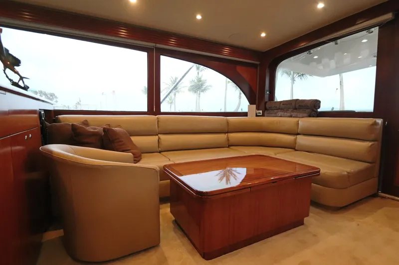 Bolita Yacht Photos Pics Luxurious interior of 2002 Buddy Davis 74 yacht with leather seating and wooden table.