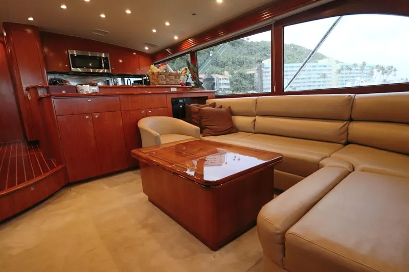 Bolita Yacht Photos Pics Luxurious interior of a 2002 Buddy Davis 74 yacht with leather seating and wooden cabinetry.