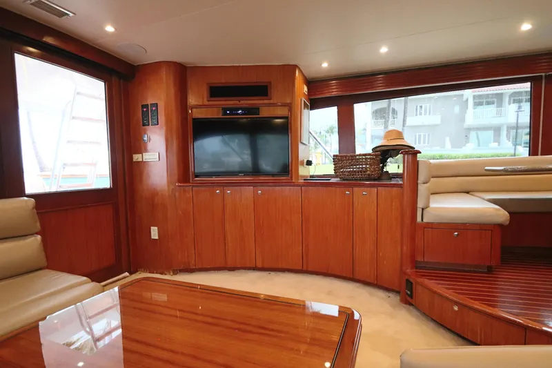 Bolita Yacht Photos Pics Luxurious interior of 2002 Buddy Davis 74 yacht with wood paneling and seating area.