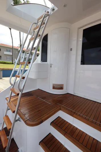 Bolita Yacht Photos Pics Staircase on 2002 Buddy Davis 74 yacht with wooden deck and sleek design.