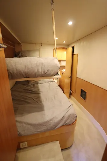 Bolita Yacht Photos Pics Interior of 2002 Buddy Davis 74 yacht with bunk beds and wooden cabinetry.