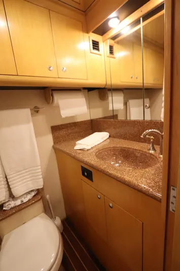 Bolita Yacht Photos Pics Luxurious bathroom in 2002 Buddy Davis 74 yacht with wood cabinetry and granite countertop.