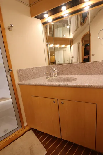 Bolita Yacht Photos Pics Luxury bathroom in 2002 Buddy Davis 74 yacht with granite countertop and mirrored cabinet.