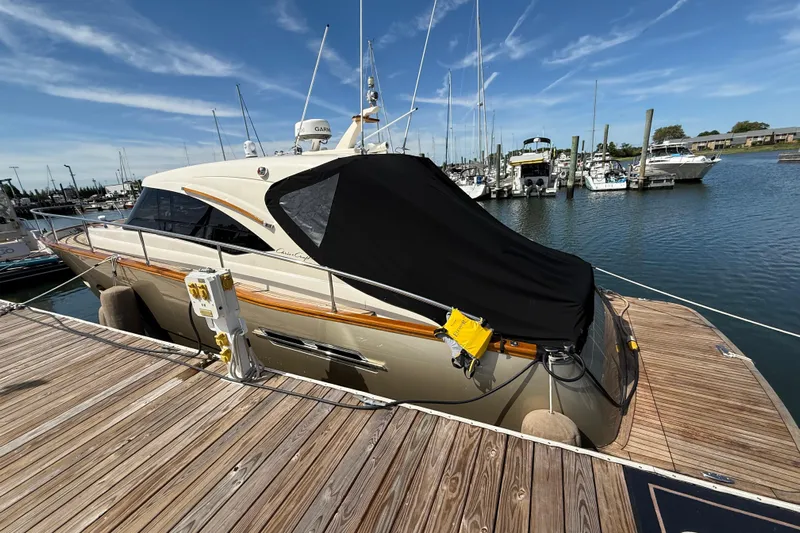  Yacht Photos Pics 2018 Chris-Craft Commander 44 yacht docked at marina under clear blue sky.