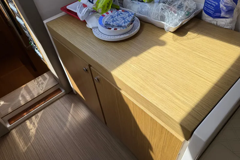  Yacht Photos Pics Wooden cabinet in 2018 Chris-Craft Commander 44 boat interior, with items on top.