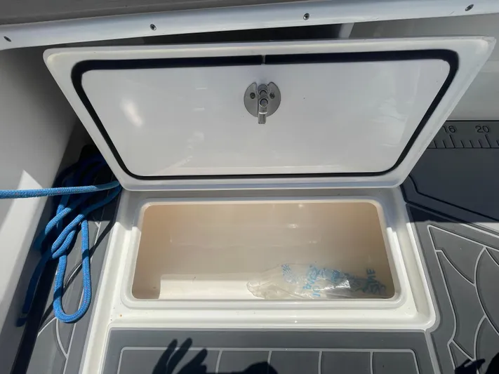 Motivated Yacht Photos Pics Open storage compartment on 2022 Contender 25 Tournament boat with blue rope inside.