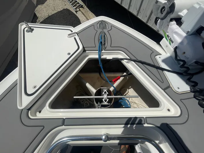 Motivated Yacht Photos Pics Anchor storage compartment on 2022 Contender 25 Tournament boat, featuring ropes and anchor equipment.