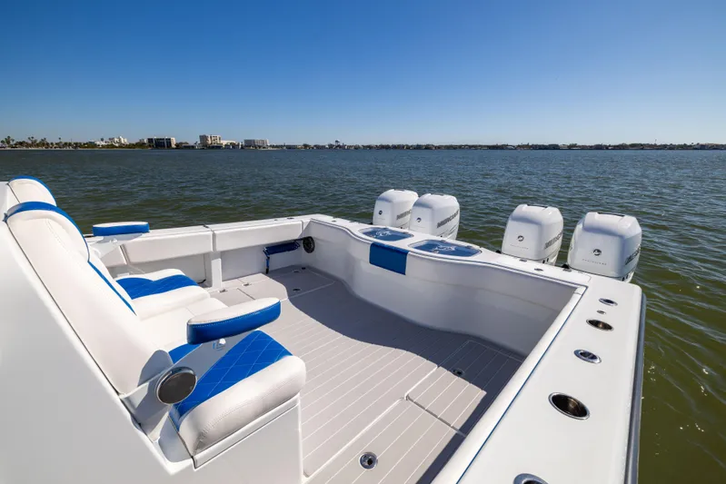  Yacht Photos Pics 2022 Freeman 42 LR boat with blue seating and four engines on a calm lake.