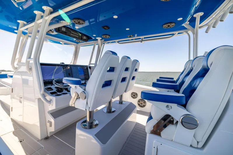  Yacht Photos Pics Interior of 2022 Freeman 42 LR boat with blue and white seating and advanced navigation system.