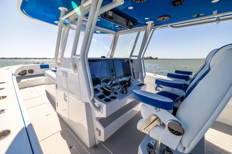  Yacht Photos Pics 2022 Freeman 42 LR boat interior with blue and white seating, advanced navigation system.