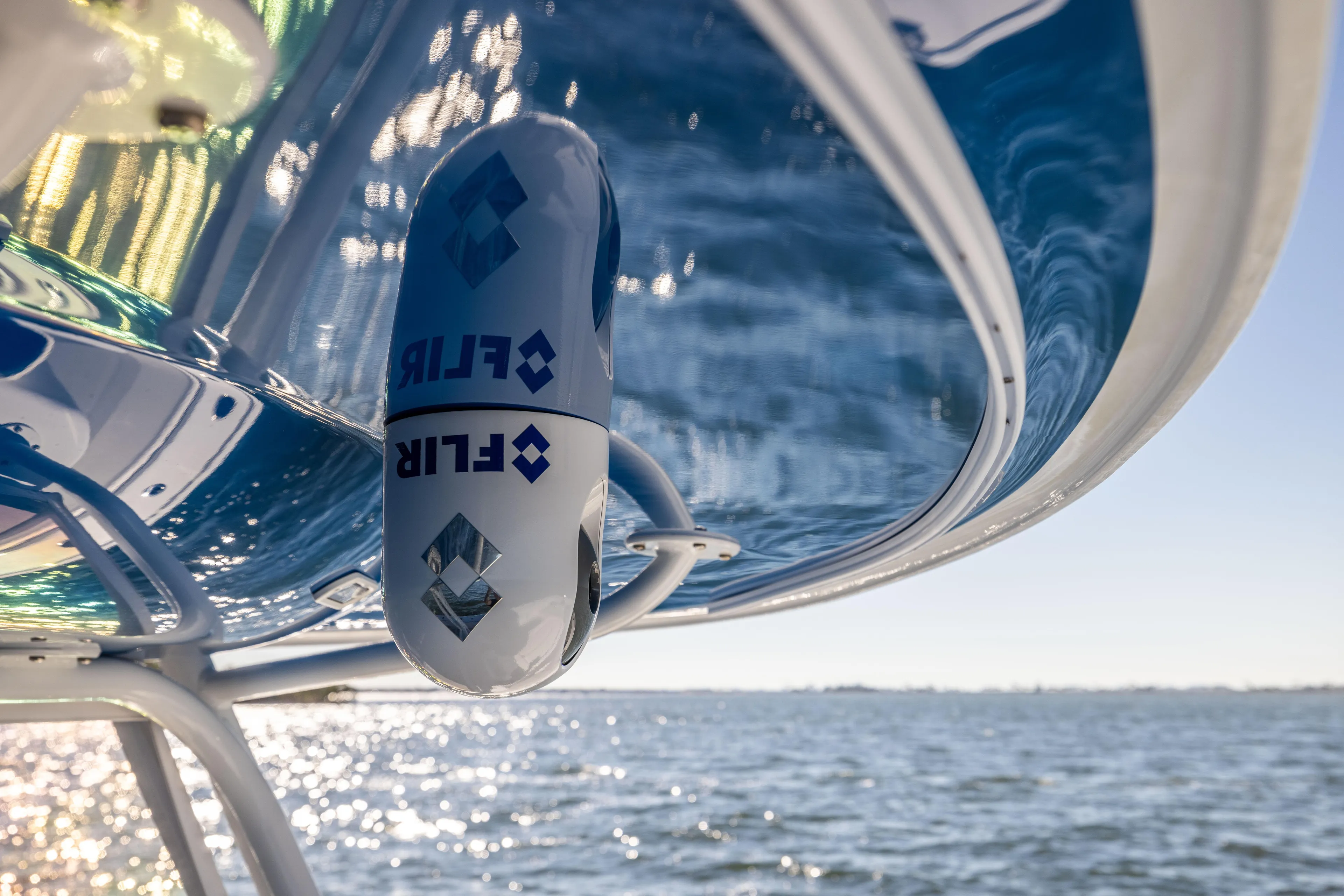  Yacht Photos Pics Freeman 42 LR 2022 boat with FLIR camera, reflecting sunlight over water.