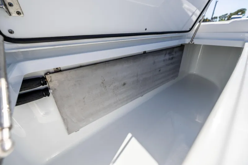  Yacht Photos Pics Freeman 42 LR 2022 boat storage compartment with open lid and metal panel.