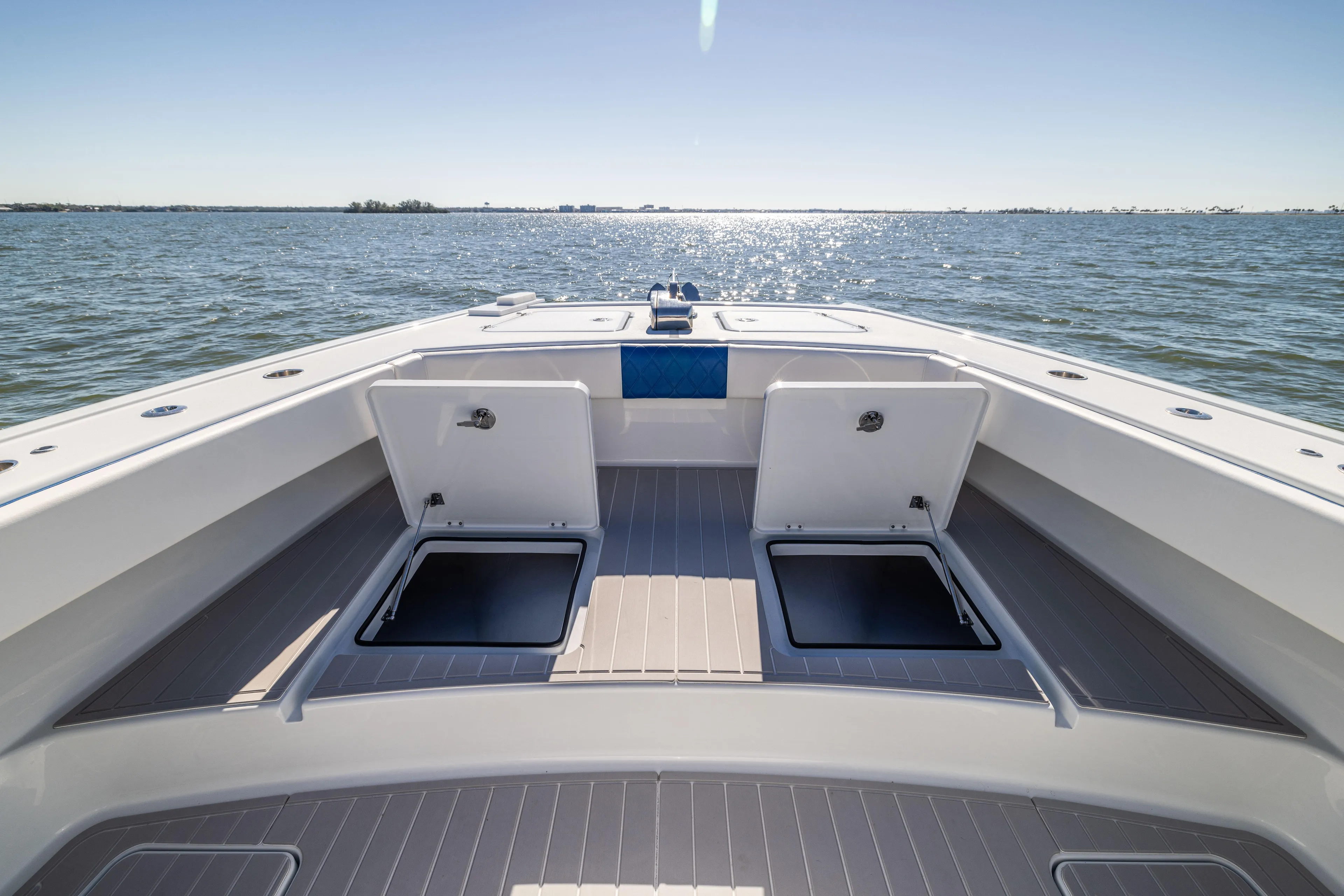  Yacht Photos Pics 2022 Freeman 42 LR boat deck with open storage, on calm water.
