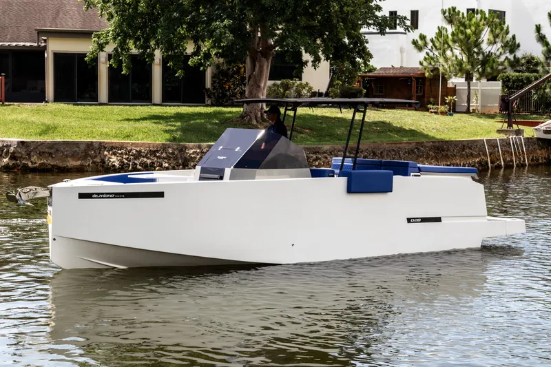  Yacht Photos Pics 2024 De Antonio Yachts D28 Open, sleek white design, cruising on a calm river.