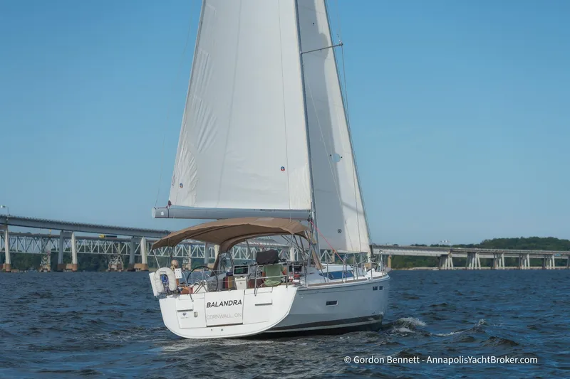 Balandra Yacht Photos Pics 2014 Jeanneau Sun Odyssey 439 sailing near a bridge on a sunny day.