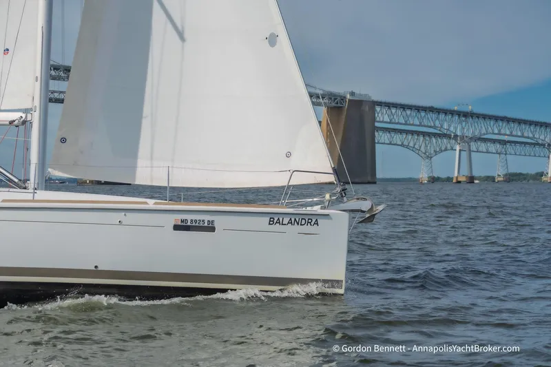 Balandra Yacht Photos Pics 2014 Jeanneau Sun Odyssey 439 sailboat cruising near a large bridge.