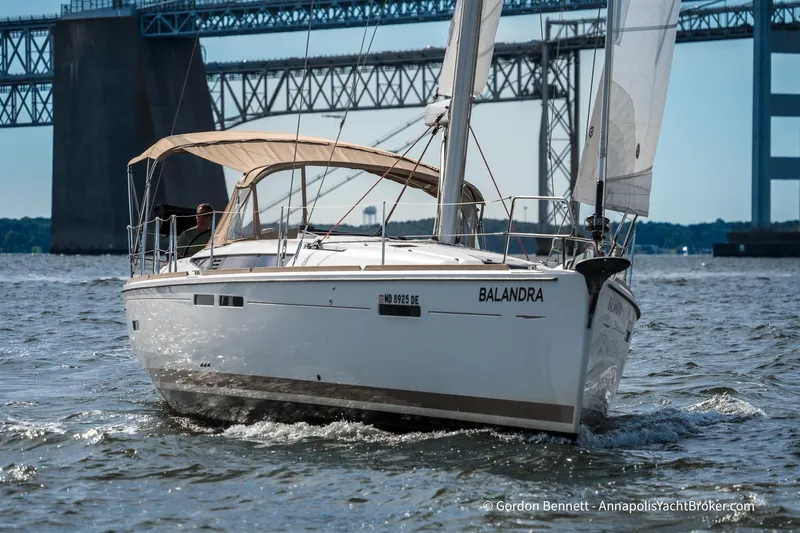 Balandra Yacht Photos Pics 2014 Jeanneau Sun Odyssey 439 sailboat cruising under a bridge on open water.