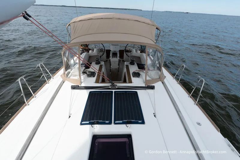 Balandra Yacht Photos Pics 2014 Jeanneau Sun Odyssey 439 sailboat on open water, featuring solar panels and a covered cockpit.