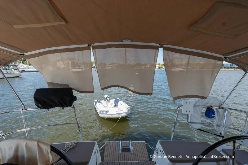 Balandra Yacht Photos Pics 2014 Jeanneau Sun Odyssey 439 yacht with canopy, overlooking water and small boat.