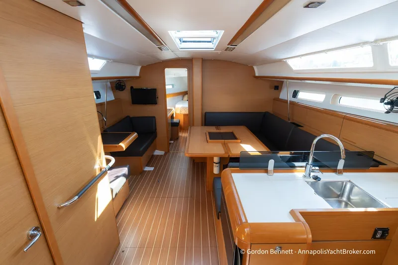 Balandra Yacht Photos Pics Interior of 2014 Jeanneau Sun Odyssey 439 yacht, featuring modern wood finish and seating area.