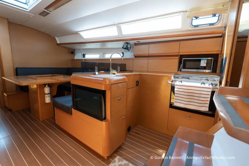 Balandra Yacht Photos Pics Interior of 2014 Jeanneau Sun Odyssey 439 yacht with modern kitchen and dining area.