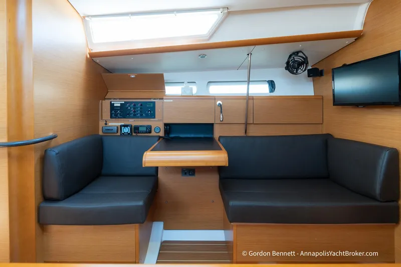 Balandra Yacht Photos Pics Interior of 2014 Jeanneau Sun Odyssey 439 yacht with seating and navigation panel.