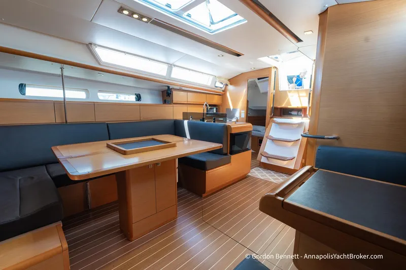 Balandra Yacht Photos Pics Interior of 2014 Jeanneau Sun Odyssey 439 yacht with modern wood finish and seating area.