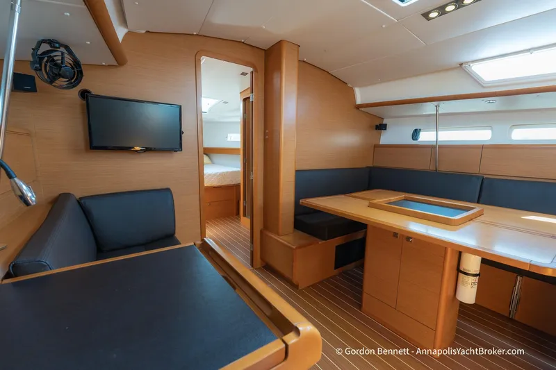 Balandra Yacht Photos Pics Interior of 2014 Jeanneau Sun Odyssey 439 yacht with modern wood finish and seating area.