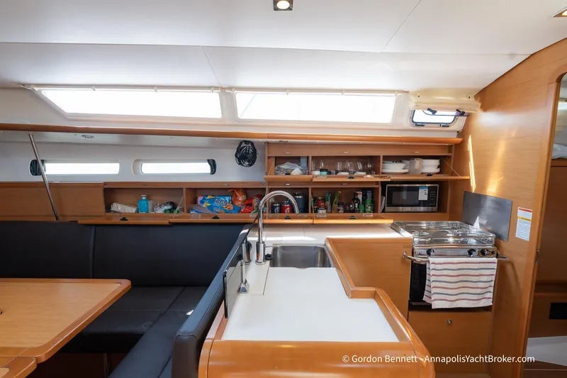 Balandra Yacht Photos Pics Interior of 2014 Jeanneau Sun Odyssey 439 yacht, featuring a modern kitchen and dining area.