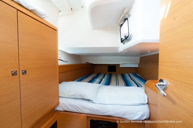 Balandra Yacht Photos Pics Cozy cabin interior of 2014 Jeanneau Sun Odyssey 439 yacht with striped bedding.