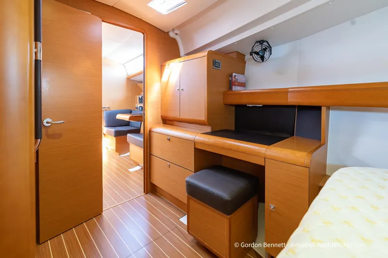 Balandra Yacht Photos Pics Interior of 2014 Jeanneau Sun Odyssey 439 yacht with wooden cabinetry and seating area.