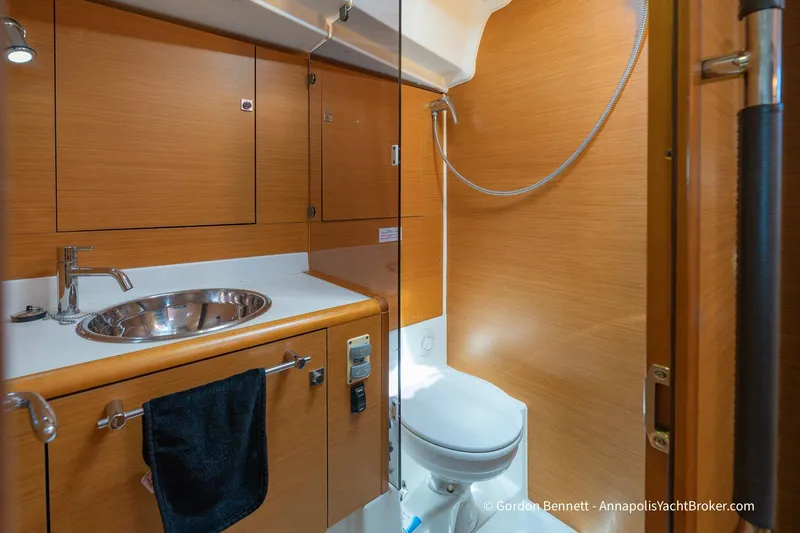 Balandra Yacht Photos Pics 2014 Jeanneau Sun Odyssey 439 yacht bathroom with wooden cabinetry and modern fixtures.