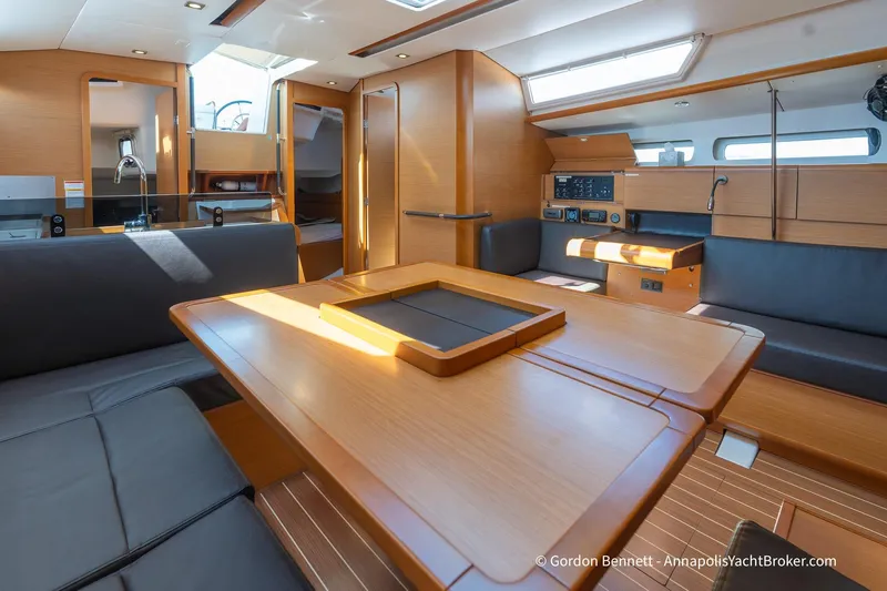 Balandra Yacht Photos Pics Interior of 2014 Jeanneau Sun Odyssey 439 yacht with modern wood finish and seating area.