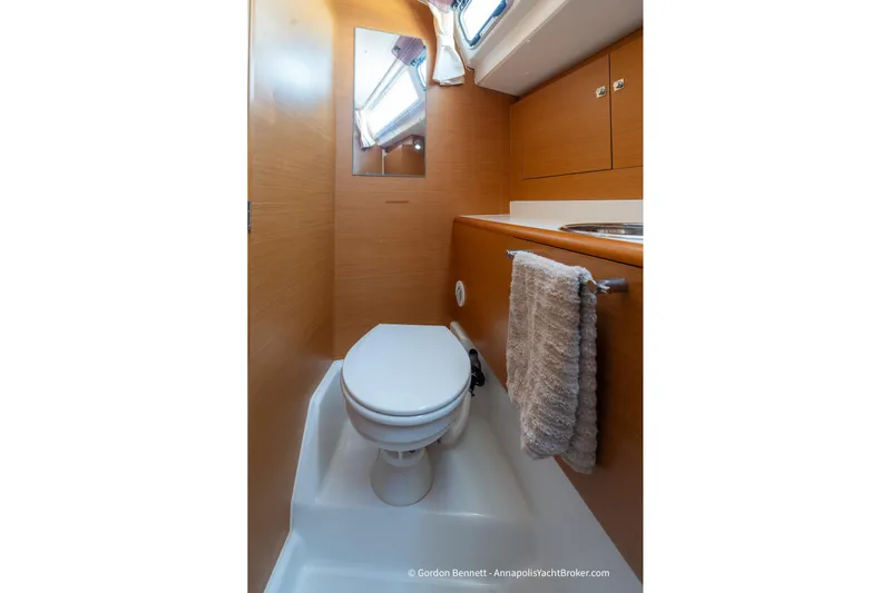 Balandra Yacht Photos Pics 2014 Jeanneau Sun Odyssey 439 yacht bathroom with wooden cabinetry and modern fixtures.