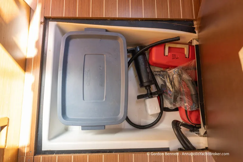 Balandra Yacht Photos Pics Storage compartment on a 2014 Jeanneau Sun Odyssey 439 yacht with equipment and containers.