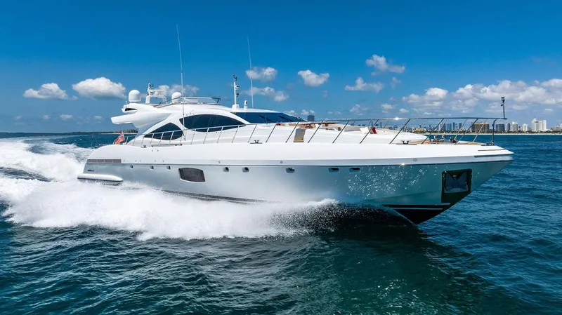 Mixed Emotions Yacht Photos Pics 2014 Mangusta 110 yacht cruising on open water under a clear blue sky.