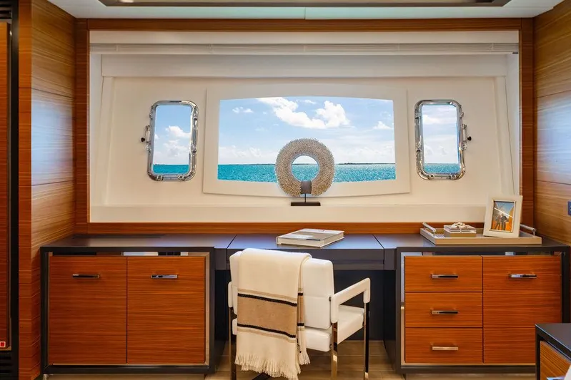 Mixed Emotions Yacht Photos Pics Luxurious interior of 2014 Mangusta 110 yacht with ocean view through large window.