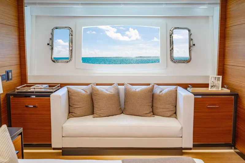 Mixed Emotions Yacht Photos Pics Luxurious interior of 2014 Mangusta 110 yacht with ocean view through large window.