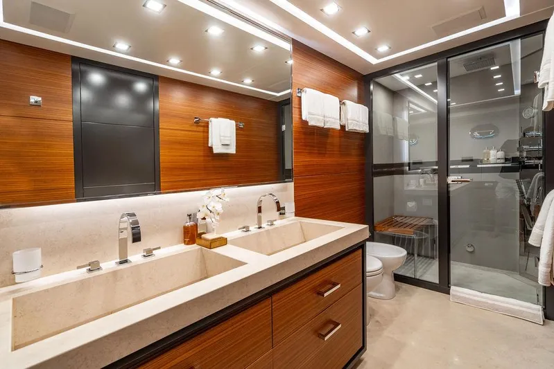 Mixed Emotions Yacht Photos Pics Luxurious bathroom in 2014 Mangusta 110 yacht with dual sinks and modern shower.