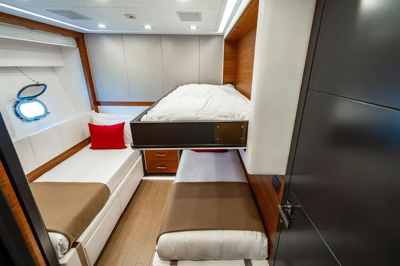 Mixed Emotions Yacht Photos Pics Luxurious 2014 Mangusta 110 yacht cabin with modern bunk beds and elegant wood accents.