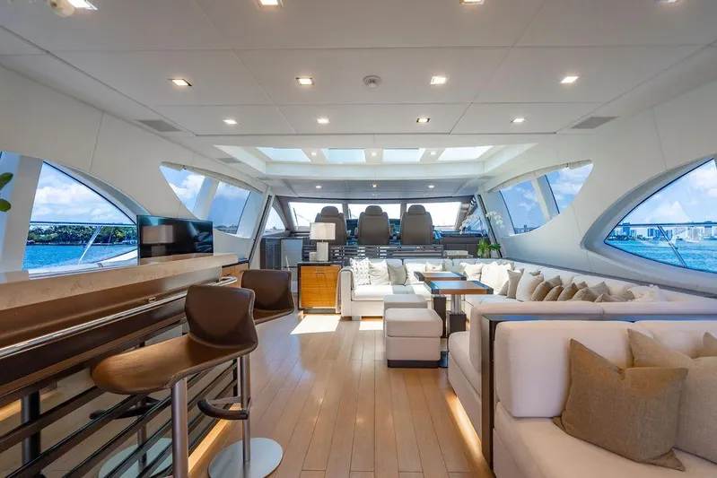 Mixed Emotions Yacht Photos Pics Luxurious interior of 2014 Mangusta 110 yacht with modern seating and panoramic windows.